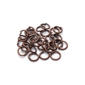Macro detail of antique bronze jump rings for DIY jewelry making and metal connections - Antique Red Copper (flat End Needs To Be Broken Open)