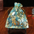 Light blue organza gift bag with gold foil rose pattern and drawstring closure - Lake Blue