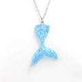 Detailed view of a blue gradient mermaid tail pendant with a shimmering resin finish - Blue