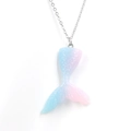Macro detail of mermaid tail pendant with blue-pink gradient and glitter finish - Pink/Blue