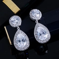 Detailed close-up of pear-shaped drop earrings with micro-pave cubic zirconia inlay - White