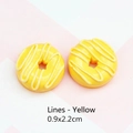 Close-up of 0.9x2.2cm yellow resin donut charms with decorative icing for DIY jewelry - 0.9x2.2cm / Striped Doughnut - Yellow