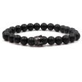 Détail d'un bracelet en perles noires mates avec un charm couronne en métal noir - Pierre Noire Couronne Noire