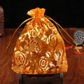 Orange organza gift pouch with gold rose pattern and drawstring closure - Orange