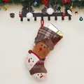Festive Christmas stockings with reindeer and snowman designs on decorative mantel hooks - Elk Style