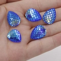 Macro shot of 13x18mm blue teardrop resin patches with fish scale texture on palm - Cyan AB (7)