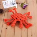 Handwoven orange cotton rope crab toy for dogs to chew and clean teeth on wood floor - Crab
