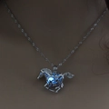 Macro shot of silver horse pendant with glowing blue luminous element on necklace - Sky Blue Luminous Horse (NY212)