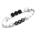 Detail of beaded bracelet with white marble stones and DAD letter beads on white background - Howlite / White