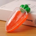 Carrot-shaped plastic candy box with a transparent outer shell and green leaf lid - Translucent Yellow