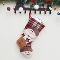 Classic Christmas stockings with plush Santa, reindeer, and snowman icons for decor - Santa Claus