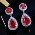 Macro detail of red pear-cut ruby drop earrings with white zircon micropave settings - Red
