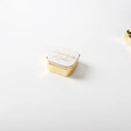 Square jewelry storage box with golden base and white ceramic lid with French text - White Storage Box