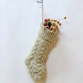 Beige cable-knit Christmas stocking with small gift boxes on a white background - Small / Flaxen