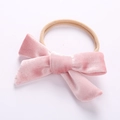 Detail of pink velvet bow on a soft nude nylon baby headband for infants - Dusty Pink