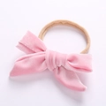 Detail of soft pink velvet bow on elastic beige nylon headband for babies - Pink