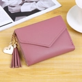 Cute pink envelope wallet for women with heart pendant and tassel on wooden desk - Watermelon red
