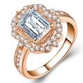 Detail of rose gold ring featuring emerald cut cubic zirconia and halo petal setting - US 6 / Rose Gold