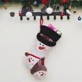 Plush Christmas stocking with 3D snowman motifs and gift boxes on festive wooden background - Snowman