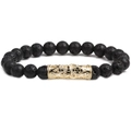 Macro detail of men's black volcanic stone beads with gold engraved metal tube - Lava Stone Cross