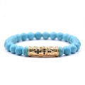 Blue stone beaded bracelet set with gold hollow cross charm and black zircons - Turquoise Cross Beaded Bracelet