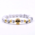 White marble bead bracelet featuring a gold paved skull head and metallic spacers - White Howlite Skull Beaded Bracelet