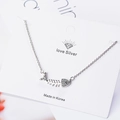Silver fishbone pendant necklace with sparkling rhinestones on a white display card - White Gold