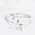 Minimalist silver-colored open bangle featuring green leaf-shaped cat-eye stones - Adjustable Open Bangle / Green Leaf Bracelet