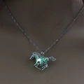 Close-up of a silver horse pendant with a green glowing bead on a mannequin neck - Yellow-Green Luminous Horse (NY213)