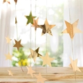 Glittering gold star garland decoration hanging over a rustic wooden surface - 4m Small Mirror Gold Star Garland