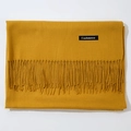Faux cashmere ginger yellow scarf with tassels shown in a folded flat lay view - Turmeric