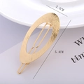Macro view of gold oval hair clip with brushed metal texture and 5.4cm length detail - Gold - Brushed Oval