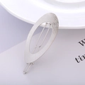 Detailed view of silver metal hair clip with brushed texture and oval ring design - Silver - Brushed Oval