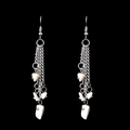 Macro detail of handmade bohemian silver tassel earrings with white natural crystal stones - White Crystal