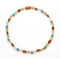 Natural Baltic amber and turquoise beaded baby necklace on a clean white background - Beaded Style / Multicolor