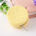 Close-up of yellow silicone coin purse with unique hammered texture and metal zipper - Yellow