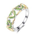 Two-tone heart ring with green zircon stones shown from a side angle on white background - US 7 / Green
