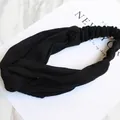 Elastic knitted twist headband in black ribbed fabric for women winter hair styling - Knitted Black