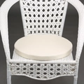 Beige round outdoor chair cushion with waterproof fabric on a white wicker chair - White