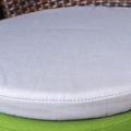 Stack of grey and green waterproof round outdoor chair cushions with woven texture - Gray