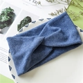 Detail of blue ribbed knit cross-knot headband texture on decorative white tray - Blue
