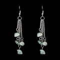 Detail of silver chain earrings featuring light green natural crystal stone tassels - Green Aventurine