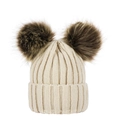 Detail view of beige knitted baby hat featuring two large fluffy faux fur pompoms - Beige