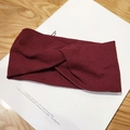 Knitted headband in deep burgundy with cross knot design and ribbed texture pattern - Burgundy