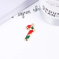 Christmas candy cane pendant in red and green enamel on a minimalist white table setup - No.9 Candy Cane