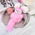 Cute pink and white plush fox keychain with fluffy faux fur and a closed-eye design - Light Pink