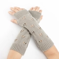 Detail of grey knitted fingerless arm warmers with heart cutout and ribbed cuffs - Light Gray