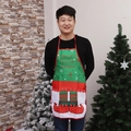 Christmas Santa's Little Helper red non-woven apron on adult model with festive trees - Santa Elf Legs Apron