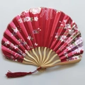 Detail of red silk folding fan with Japanese floral patterns and a red silk tassel - No. 14 Wine Red
