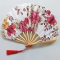 Close-up of Japanese style folding fan featuring pink floral patterns and red tassel - No.13 Red Flower